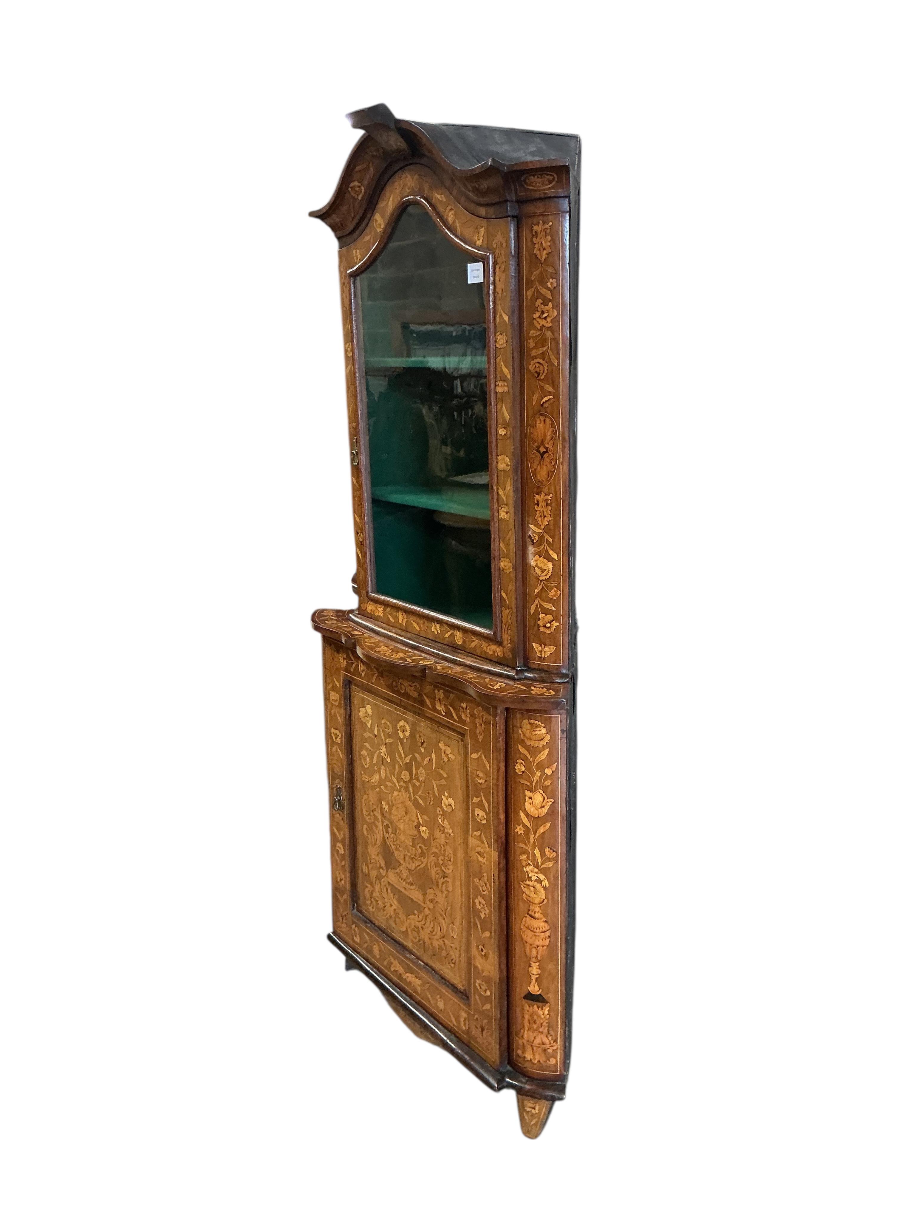 An early 19th century Dutch floral marquetry inlaid walnut standing corner cabinet, width 87cm, depth 53cm, height 192cm